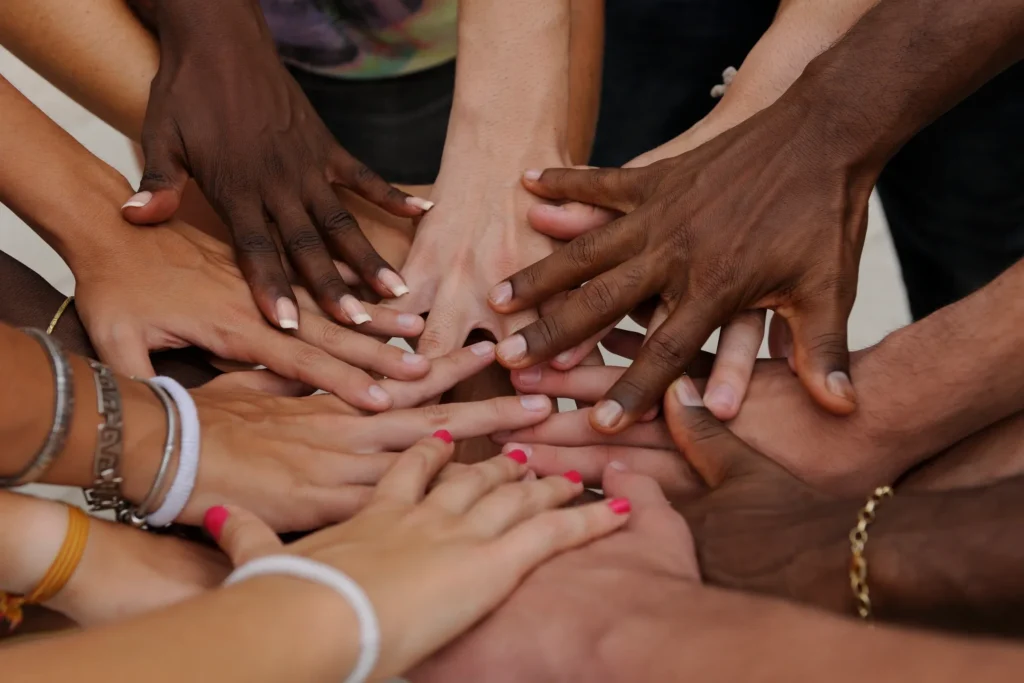 A group of people with their hands together.