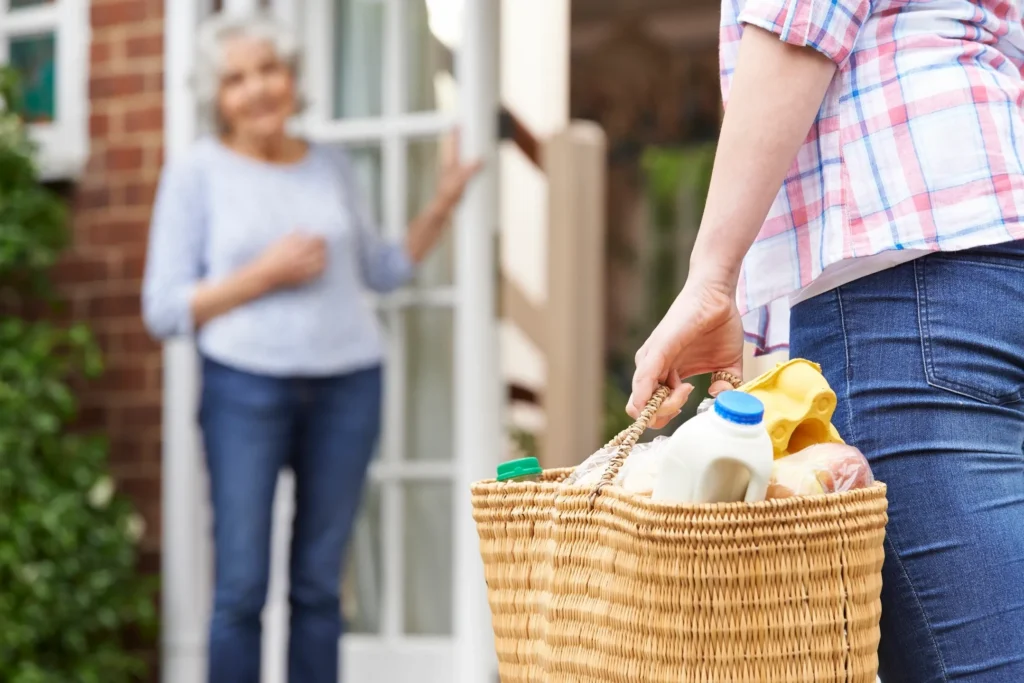 A person holding a basket full of food.