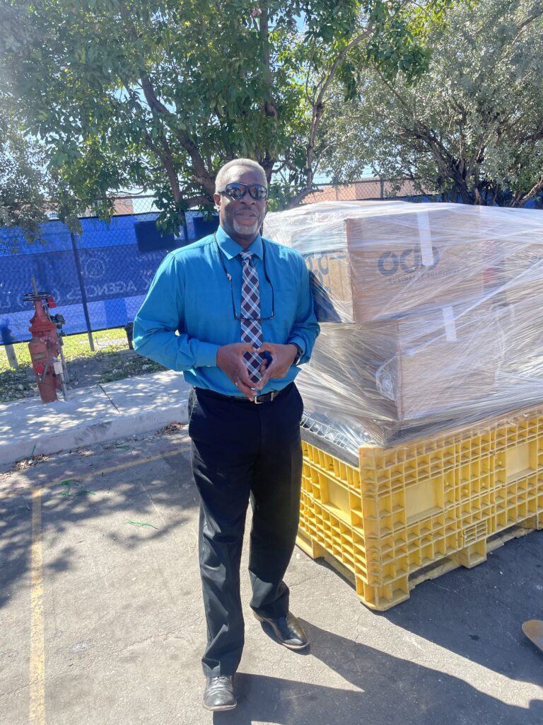 A man standing in front of boxes on the ground.