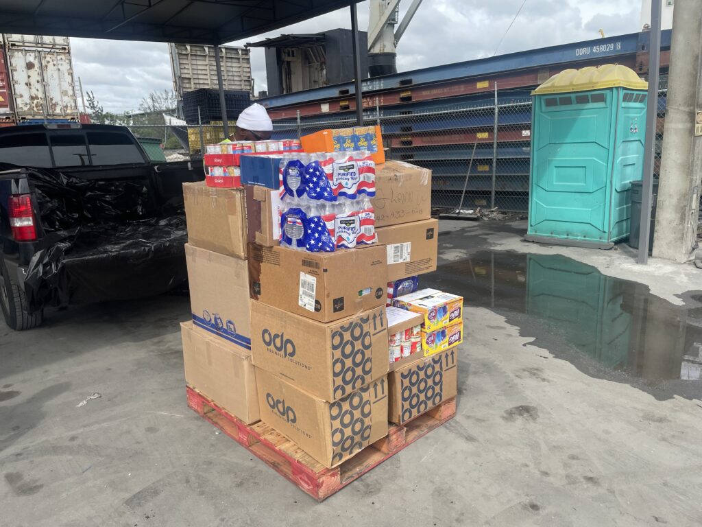 A pallet of boxes and cups on top of it.